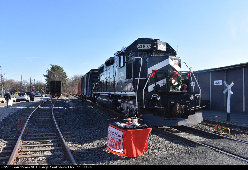 View of the train with the Builders General Supply building on the right-note the Operation Toy Train table to the left of the train